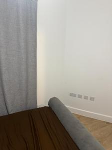 a bed in a room with a window at one bedroom-modern-luxury-private-free wifi-gravesend in Gravesend