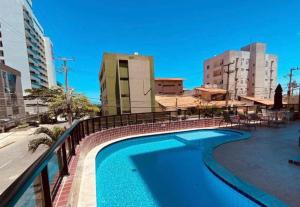 a swimming pool on the side of a building at Ap studio a 50m da praia in Maceió