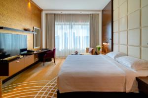 Uma cama ou camas num quarto em Asiana Hotel Dubai