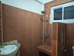 a bathroom with a shower and a sink at Gold house apartment in Vientiane +55 photos