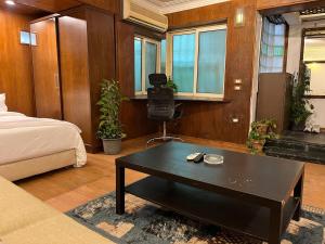 a bedroom with a bed and a coffee table at Luxury Studio Zamalek in Cairo