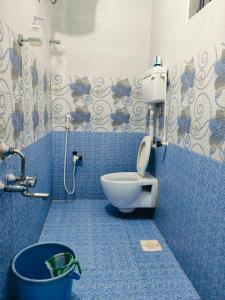 a blue bathroom with a toilet and a bucket at Studio Apartment with private entrance, behind DLF and near L&T, RMZ IT park and close to SRMC & MIOT Hospital in Chennai +24 photos