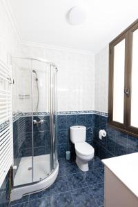 a bathroom with a toilet and a glass shower at Bilbao Urban Stay in Bilbao