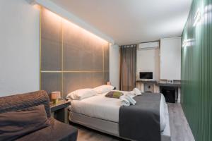 a hotel room with a bed and a chair at WELLNESS HM wellness home By Dimorra in Naples