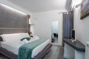 a bedroom with a bed and a television in it at WELLNESS HM wellness home By Dimorra in Naples