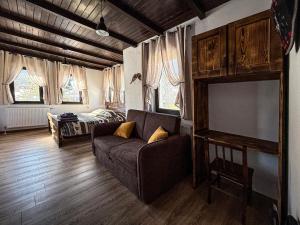 a living room with a couch and a bed at Къща за гости МЕЧА СТЪПКА in Gela