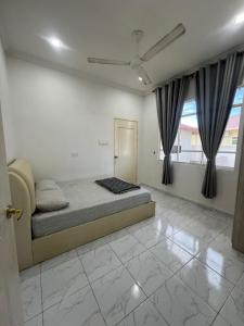 a bedroom with a bed and a window with curtains at Mama Homestay in Papar +3 photos
