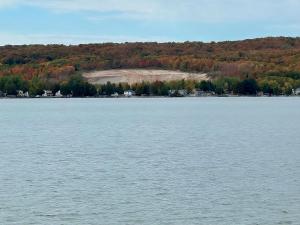 a large body of water with trees in the background at Charming 3 BR Lakefront Cottage - Gateway to Platte Lake & Sleeping Bear Dunes! in Honor