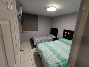 a small room with two beds and a kitchen at Puerto Vallarta Zona Romantica in Puerto Vallarta