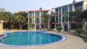 a large swimming pool in front of a building at Inani Royal Resort in Ināni