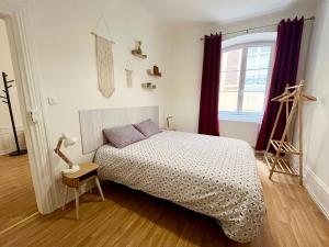 a bedroom with a bed and a window at Chez Mamema in Colmar +17 photos