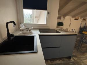 a kitchen with a sink and a counter top at Quercus Hom&xperiences in Villa Gorizia +15 photos