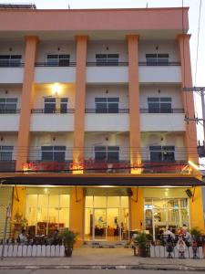 a large white building with windows and a balcony at Avalon Residence in Savannakhet