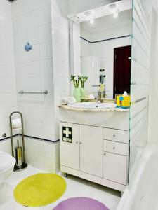 a bathroom with a sink and a toilet and a mirror at Paradise Sunshine Studio in Portimão