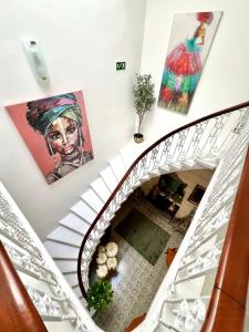an overhead view of a staircase with art on the walls at Stylish Boutique Duplex Apartment Home 'Green' - Near Valletta! 2 Large Double En-Suite Bedrooms in Msida