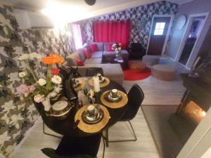 a living room with a table and a couch at Anten Lake House in Alingsås