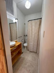 a bathroom with a sink and a toilet at Duplex peatonal in Villa Carlos Paz +16 photos