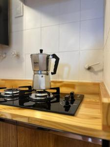 a coffee maker on top of a stove in a kitchen at Duplex peatonal in Villa Carlos Paz