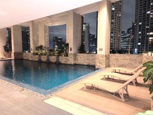 a swimming pool on the roof of a building at KL Executive Greenbelt (KLX) in Manila
