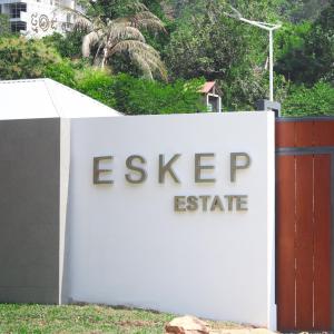 a sign that says eskipop estate behind a fence at Eskep Estate - Private Villas in Phumĭ Ŏng Char