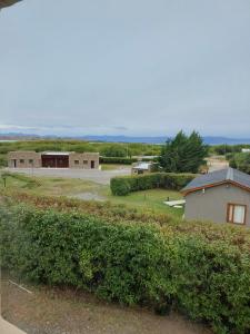 a view of a farm with a building and a field at Hostel Aonikenk in El Calafate +56 photos