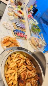 a table topped with a pot of food and snacks at Qadim Hotel in Samarkand