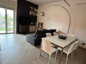 a living room with a table and a couch at La casa di Andrea in Messina