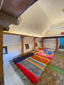 two beds in the middle of a room at the Aljulens Homestay in Si Antar