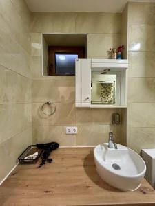 a bathroom with a white sink and a mirror at Studio Baščaršija - Sarajevo's prime location in Sarajevo +9 photos