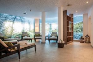 a room with a large window with a mountain view at Rauriserhof 4 Sterne Superior in Rauris