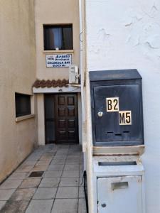 a building with a mail box in front of a door at Apartment with sea view! in Khlorakas