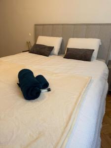 two beds with white sheets and blue towels on them at Avdina Luxury Apartment in Sarajevo