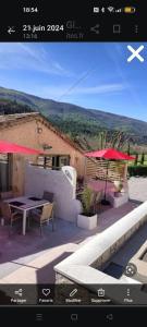a view of a patio with a table and umbrella at Gîte de la Source in Barret-sur-Meouge