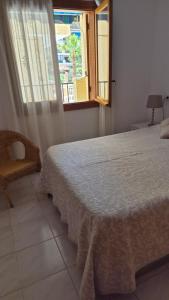 a bedroom with a bed and a window at Gladmar Apartment in La Mata +23 photos
