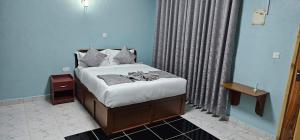 a bedroom with a bed in a blue room at Juniper Park Resort in Nyahururu +55 photos