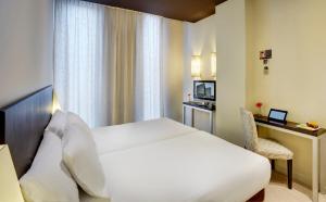 Postel nebo postele na pokoji v ubytování Sercotel Boulevard Vitoria-Gasteiz