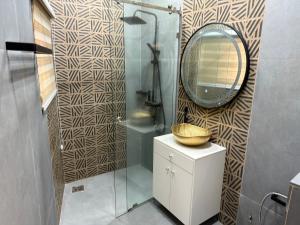a bathroom with a sink and a mirror at Luxury Apartment RDC in Lomé