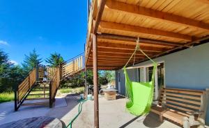 a patio with a wooden deck with a wooden stairs at Tres Piquillines in Puerto Madryn