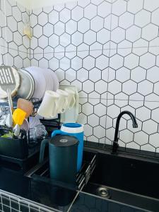 a kitchen sink filled with dishes and aaucet at Aila Homestay TTHI in Alor Setar +23 photos