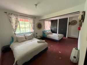 a bedroom with two beds and a window at Casa Bosco Minca in Santa Marta +51 photos
