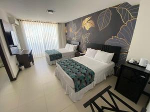 a hotel room with two beds and a television at Mai Suites Apart Hotel in Santa Cruz de la Sierra