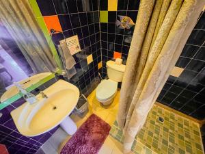 a bathroom with a sink and a toilet at Calipso Bocas Town - Cozy Caribbean House in the Center in Bocas Town +26 photos