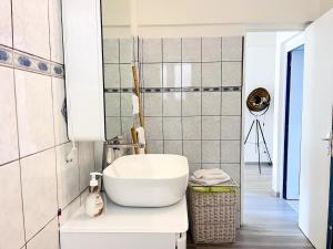 a bathroom with a white sink and a mirror at Villa K'nopée in Sainte-Marie +25 photos