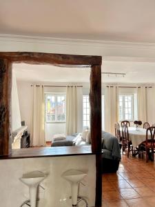 a bedroom with a bed and a table and chairs at Sabugal Comfort - Central Castelo in Sabugal