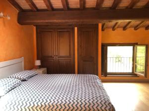 a bedroom with a bed and a window at Maison de Village TOSCAN in Poderi Rancoli +13 photos