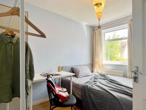 a bedroom with a bed and a desk and a window at Cozy sunlit room in west London in Yiewsley +2 photos