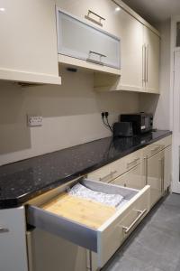a kitchen with a counter top with a drawer in it at cozy lux apartments in Brimsdown Station
