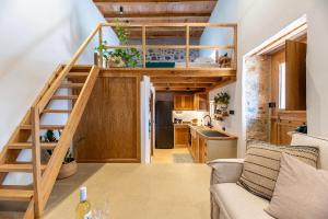 a tiny house with a staircase and a kitchen at Olivetta ,Traditional stone house in Kos Town