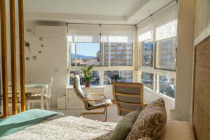 a bedroom with a bed and a table and chairs at Estudio in Torrox Costa