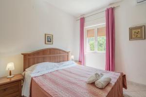 a bedroom with a large bed with purple curtains at Villa Valentina casa vacanze fontane Bianche in Fontane Bianche